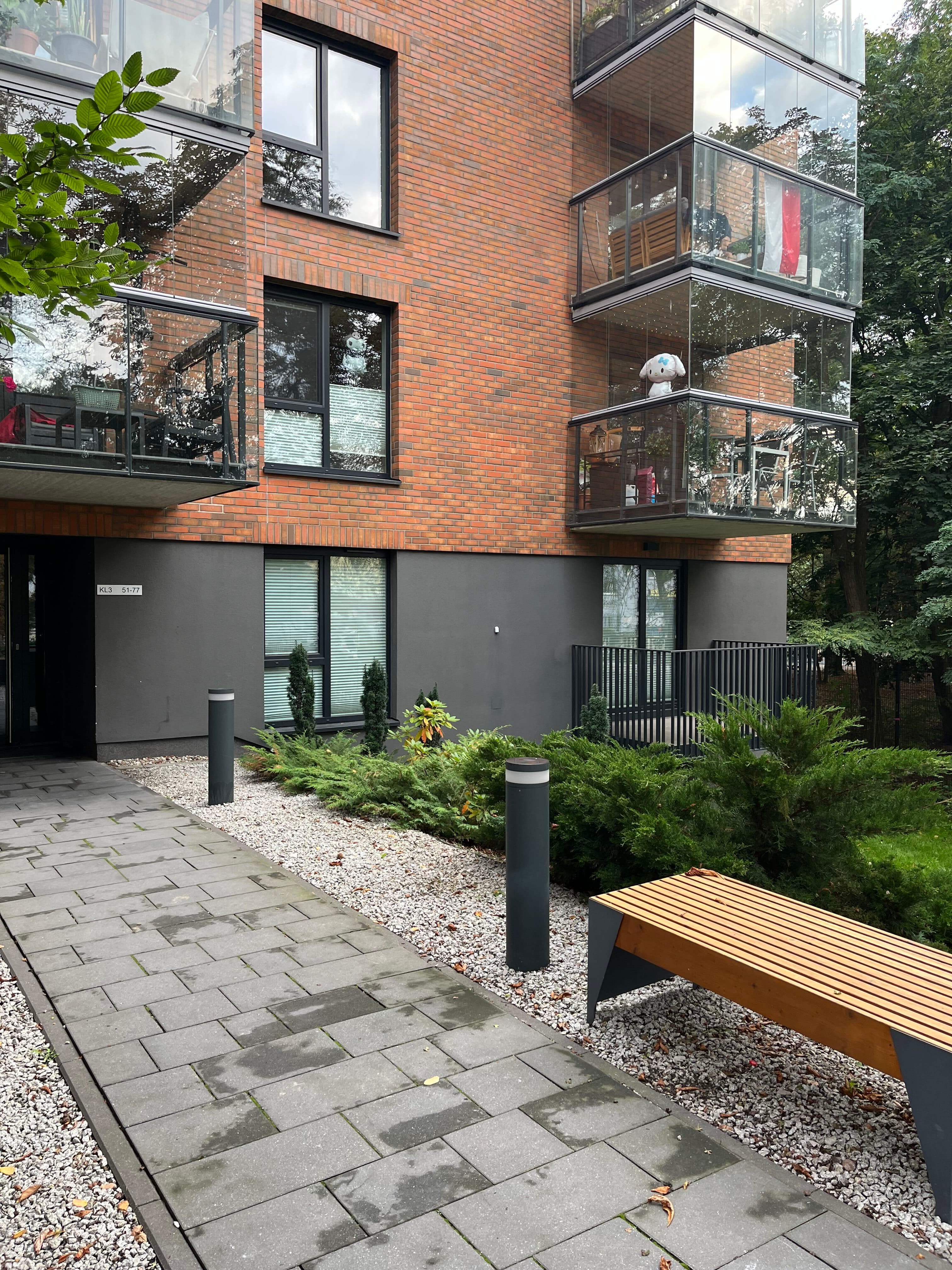 Block 1 entrance with glass balconies.