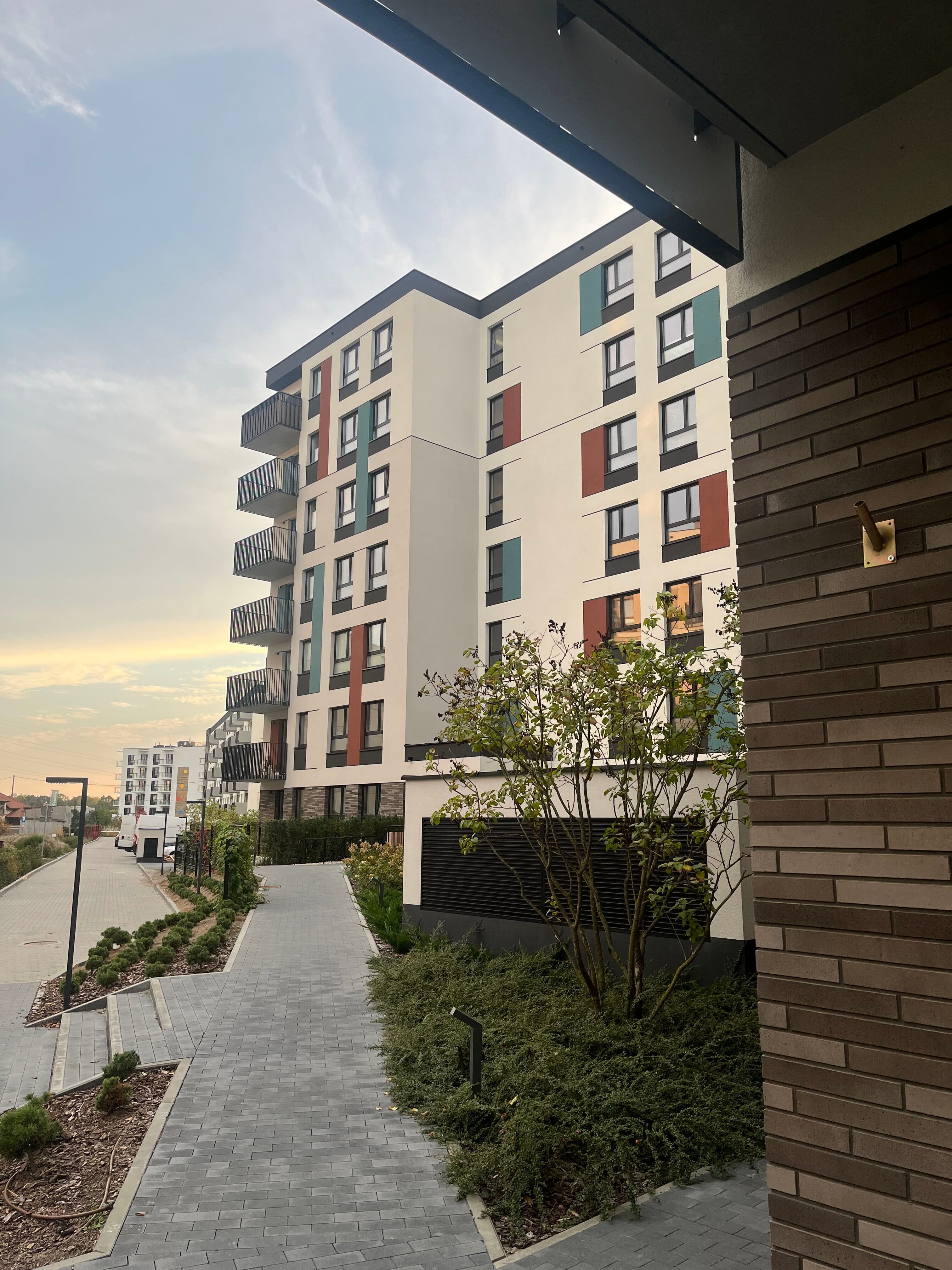 Bemosphere phase two façade — coloured recessed window panels and black balcony railings.