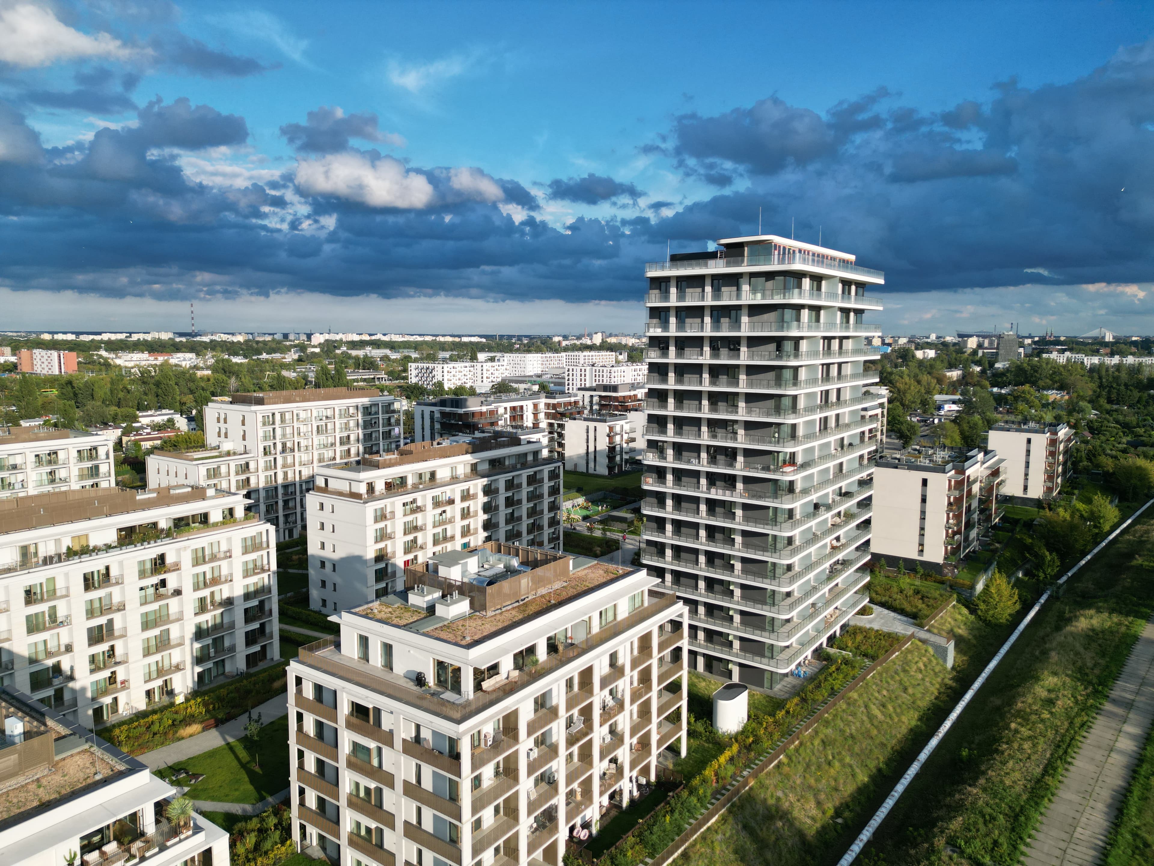 Second phase of Bulwary Praskie from above: the tall landmark tower among lower white blocks, with the Vistula path to the right.