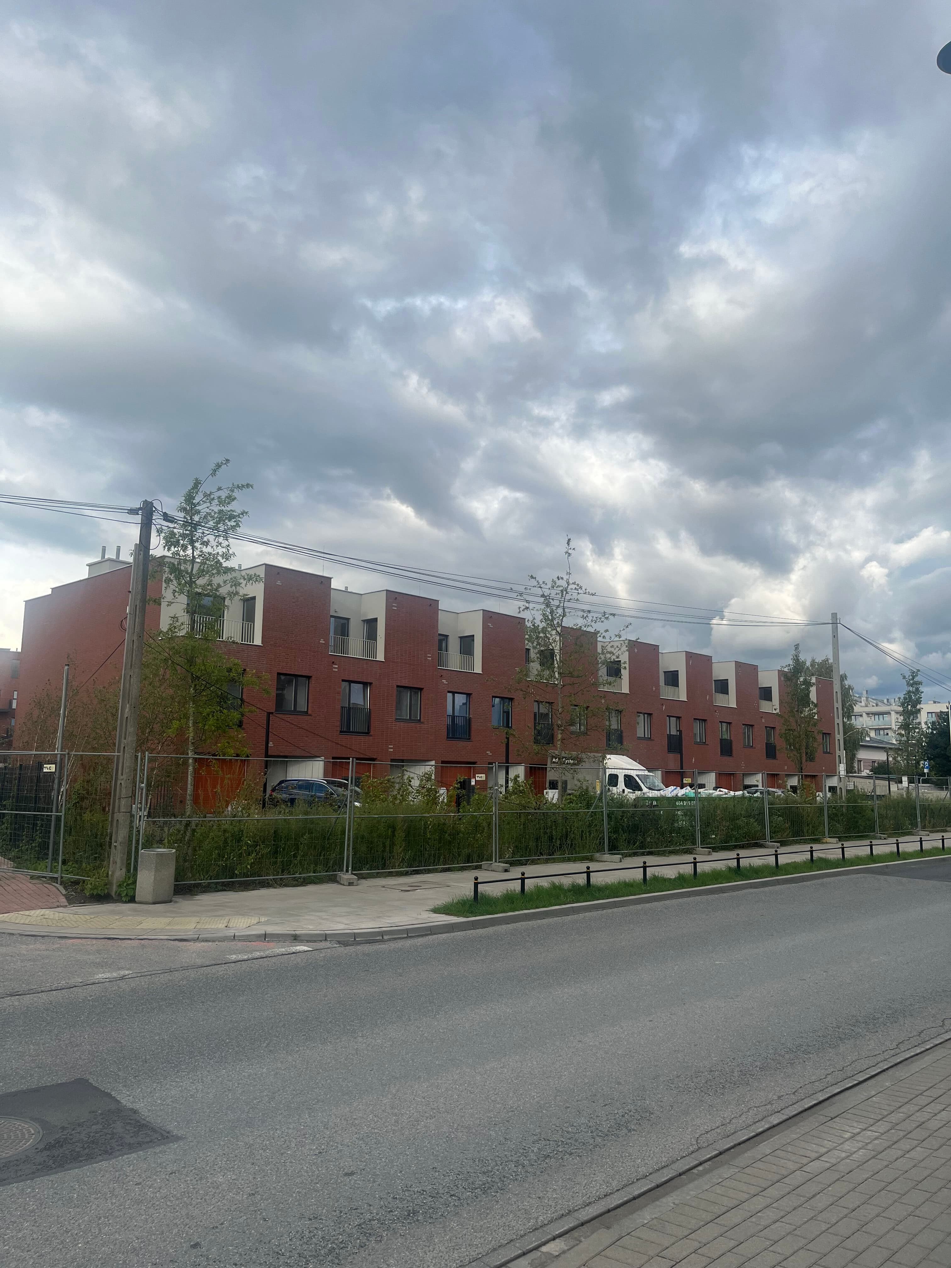 Nordic Bemowo street frontage — segmented façades along the estate edge.