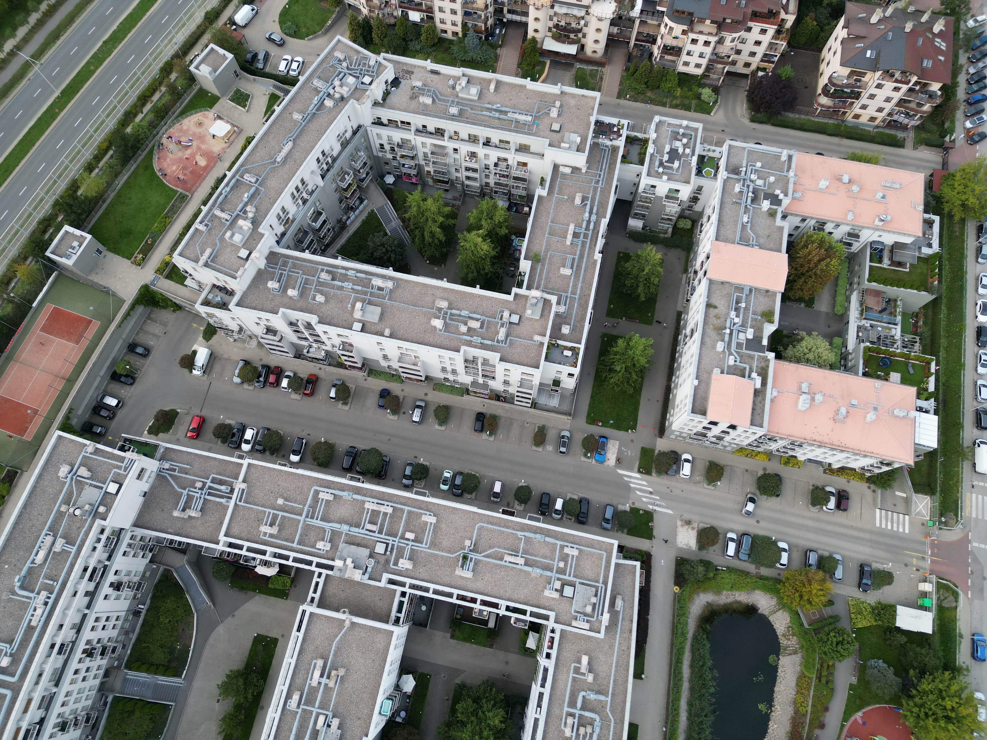 Aerial view of guest surface parking, tennis court and landscaped courtyards at Zielona Italia.