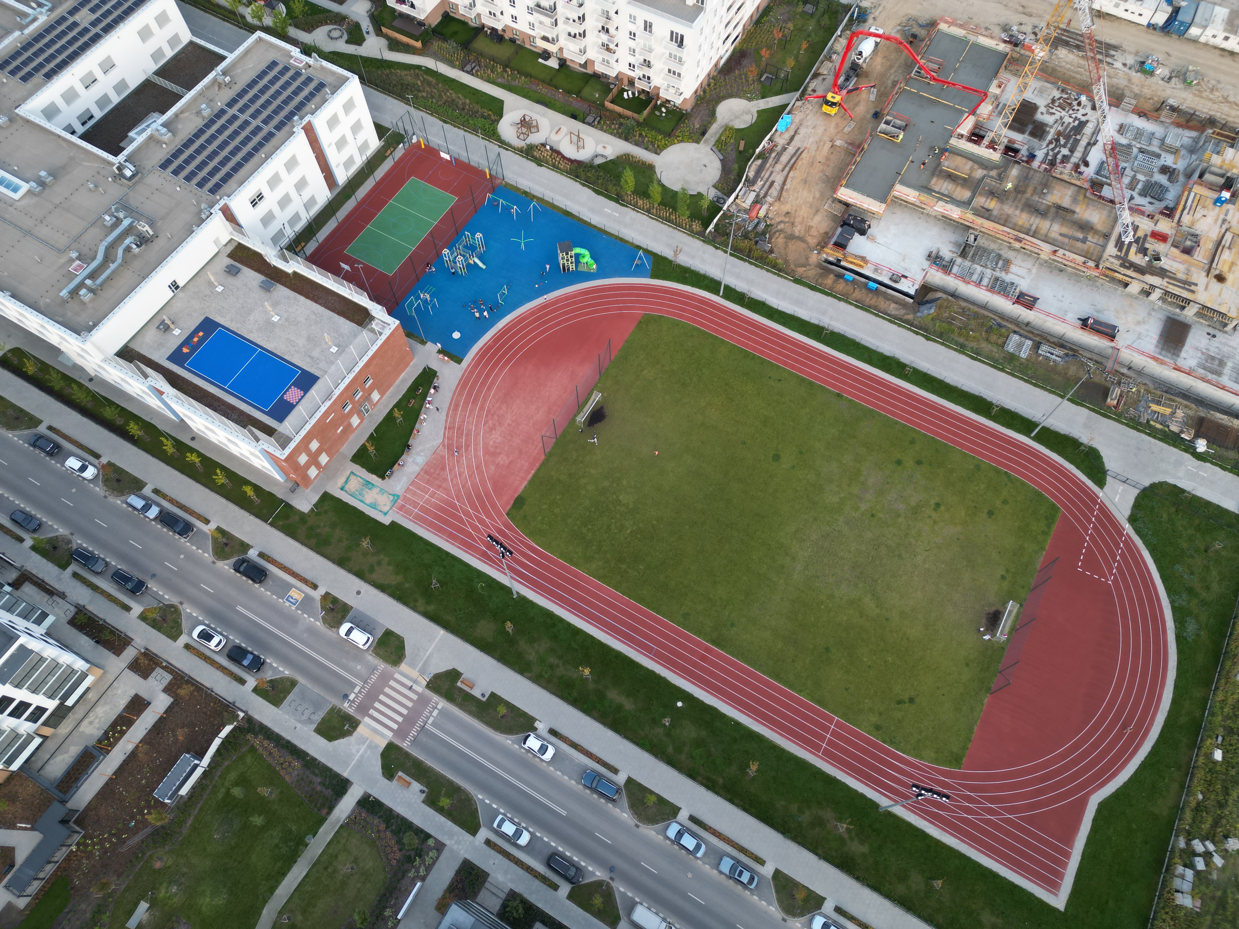 Aerial of Szkoła Podstawowa nr 407 with running track, courts and playground on Szeligowska